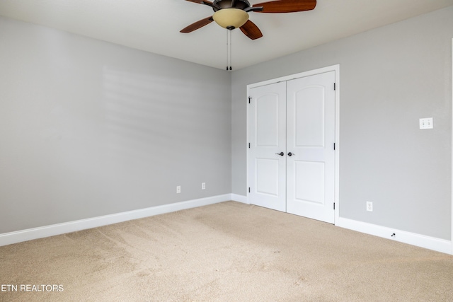 unfurnished bedroom with ceiling fan, a closet, and carpet floors