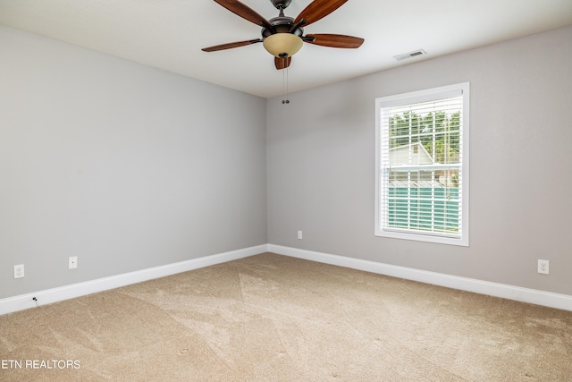 empty room with ceiling fan and carpet flooring