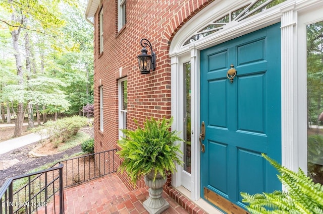 property entrance with brick siding