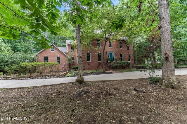 colonial inspired home with brick siding