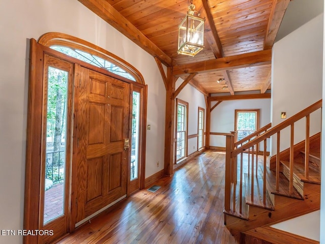 foyer entrance featuring stairs, wood ceiling, hardwood / wood-style flooring, baseboards, and visible vents
