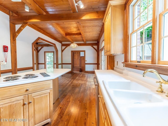 kitchen with light countertops, a sink, wooden ceiling, white electric cooktop, and light brown cabinetry