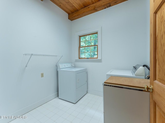 laundry area with baseboards, washer and dryer, laundry area, and wood ceiling