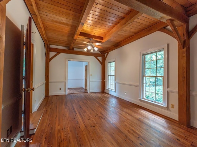 unfurnished room with wooden ceiling, baseboards, beamed ceiling, ceiling fan, and hardwood / wood-style floors