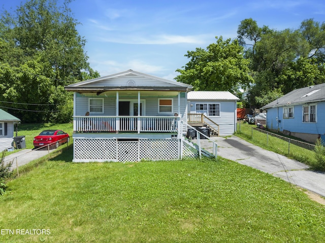 bungalow-style home with covered porch and a front yard