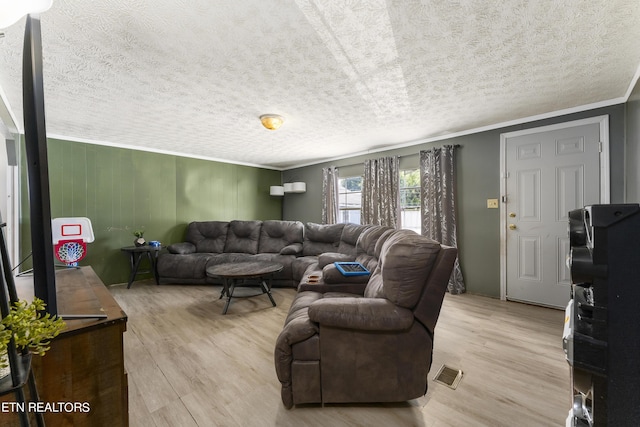 living room featuring light wood-type flooring and crown molding