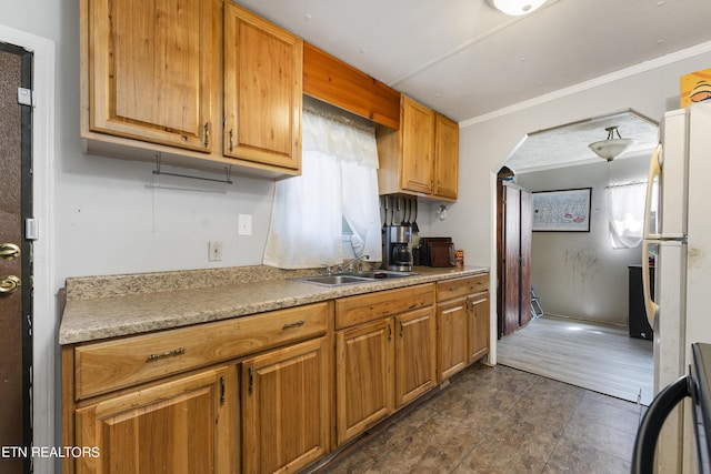 kitchen with white fridge, stove, and sink