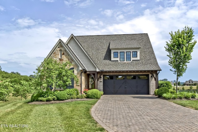 craftsman inspired home featuring a garage and a front lawn