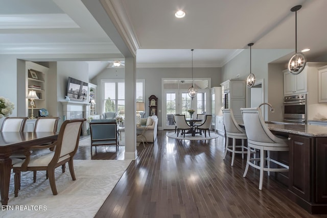 dining room featuring ceiling fan, dark hardwood / wood-style floors, and ornamental molding