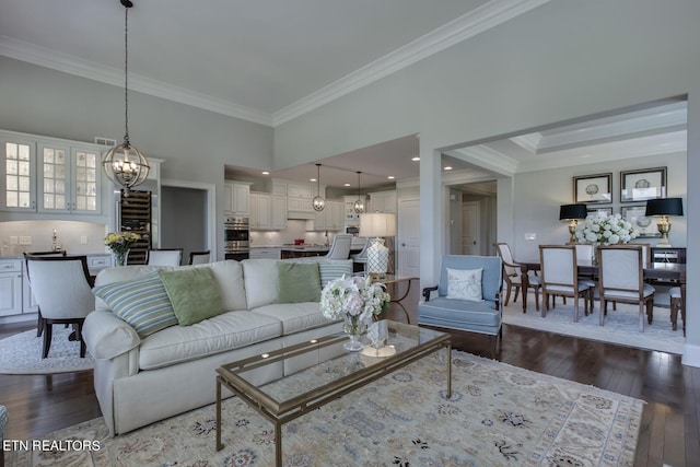 living room featuring dark wood-type flooring and crown molding