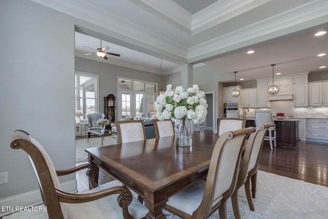 dining space with ceiling fan, sink, crown molding, french doors, and dark hardwood / wood-style flooring