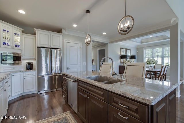 kitchen featuring appliances with stainless steel finishes, white cabinets, dark brown cabinetry, and sink