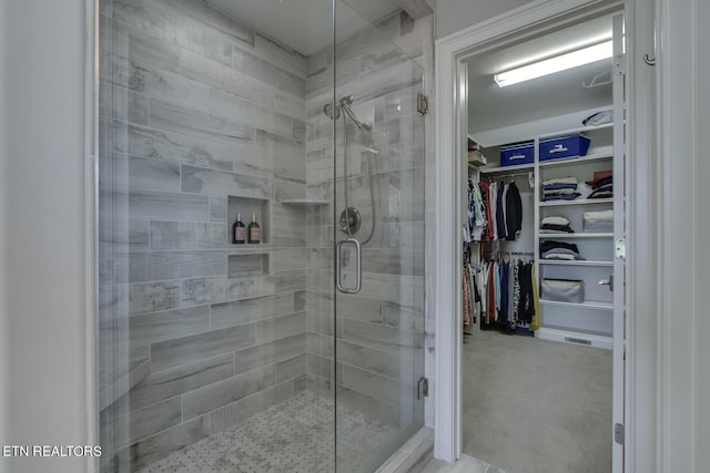 bathroom with a shower with door