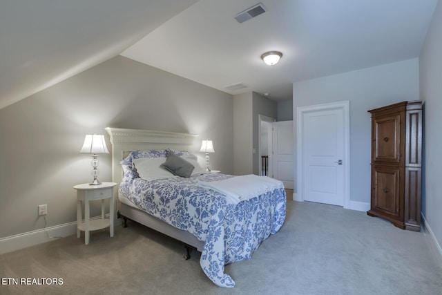 bedroom featuring carpet floors and vaulted ceiling