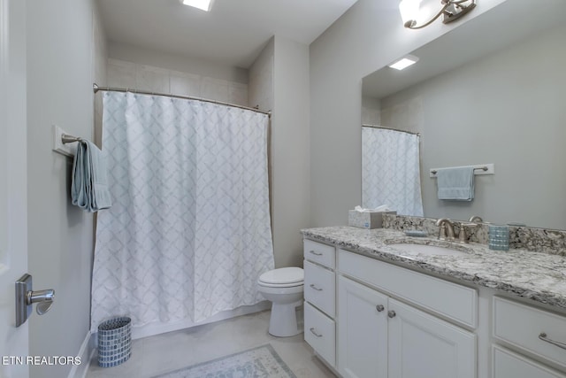 bathroom featuring toilet, vanity, and curtained shower