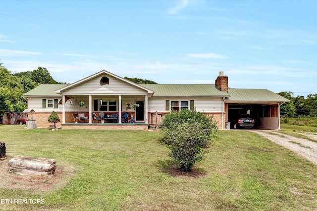 back of house featuring a yard, a carport, and covered porch