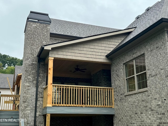 view of side of property with ceiling fan and a balcony