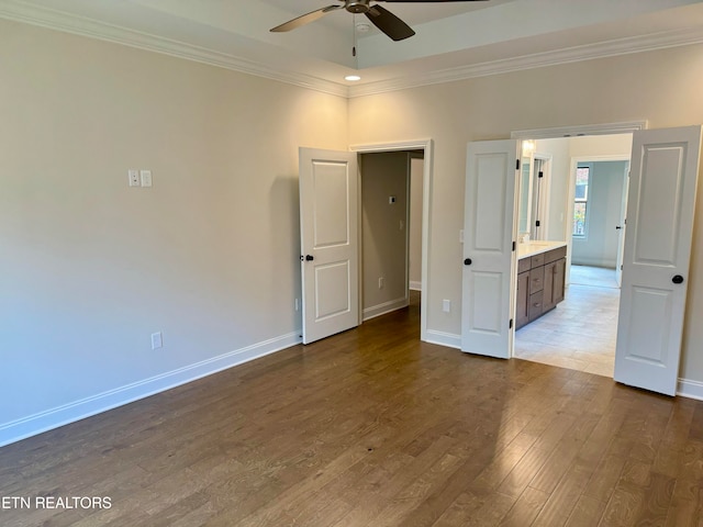 spare room featuring hardwood / wood-style floors, ceiling fan, and crown molding