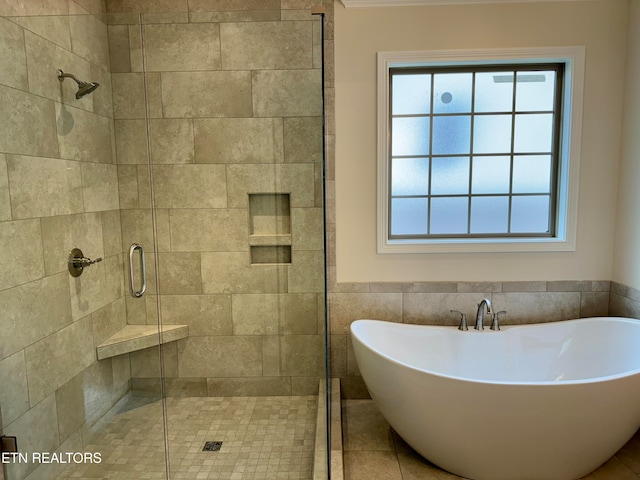 bathroom with plus walk in shower and tile walls