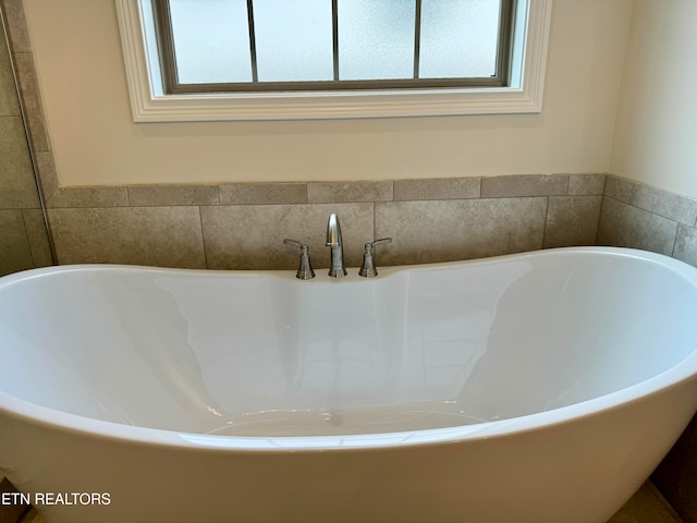 interior details featuring a tub to relax in