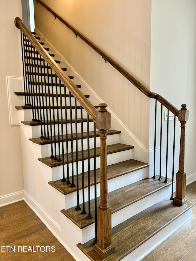 stairs with wood-type flooring