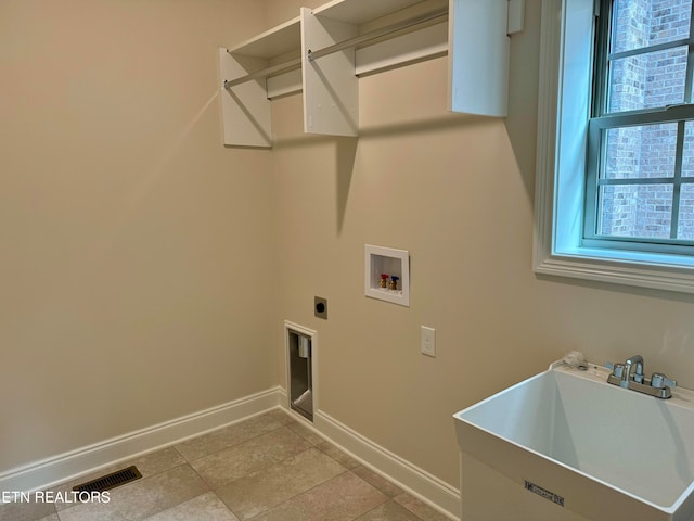 washroom featuring washer hookup, electric dryer hookup, a healthy amount of sunlight, and sink