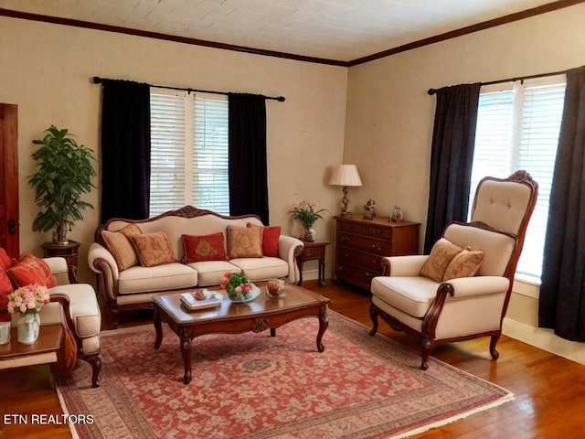 living room featuring hardwood / wood-style floors, crown molding, and a wealth of natural light