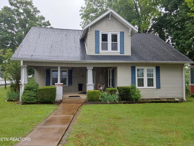 view of front of house featuring a porch and a front yard