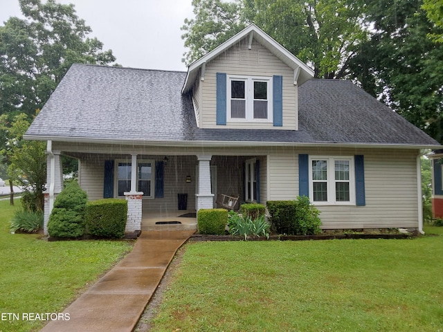 view of front of home with covered porch and a front yard