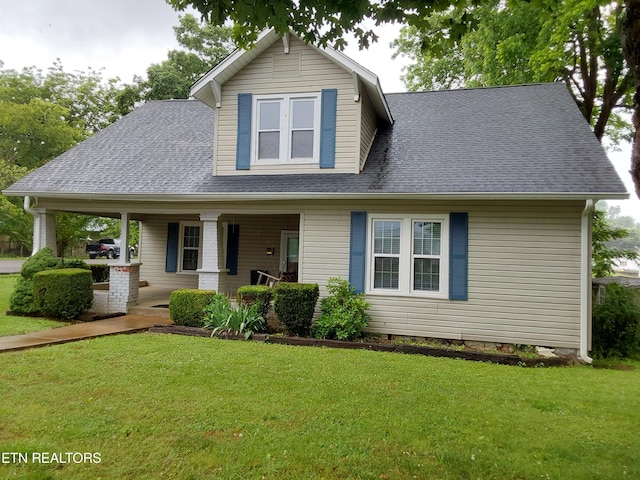 view of front of house featuring covered porch and a front yard