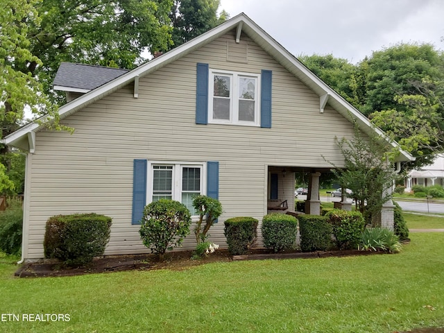 view of side of property with a lawn