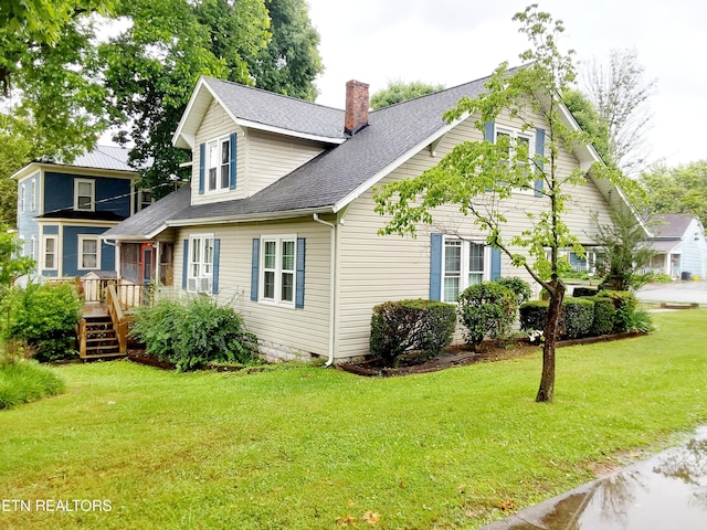 view of front facade with a deck and a front yard