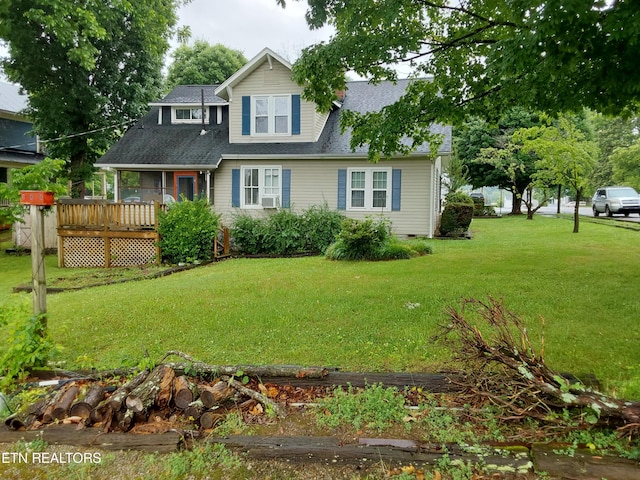 view of front of house with a wooden deck and a front lawn