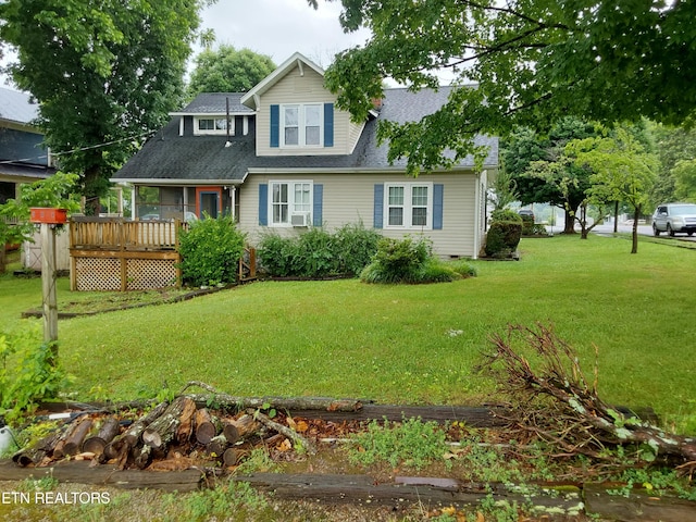 view of front of house with cooling unit, a wooden deck, and a front lawn