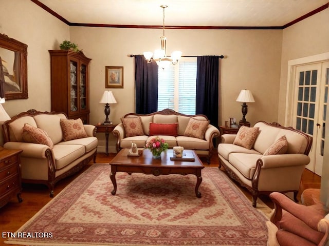 living room with a chandelier, hardwood / wood-style flooring, and crown molding