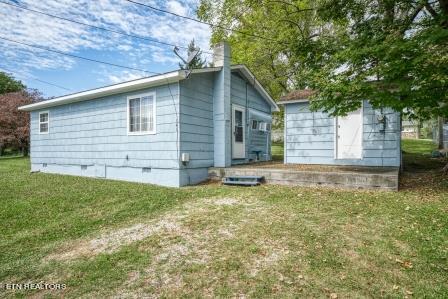 view of property exterior with a yard