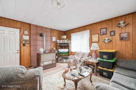 living room with wood walls