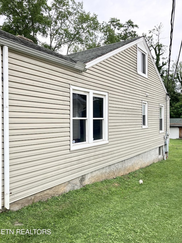 view of side of home featuring a yard