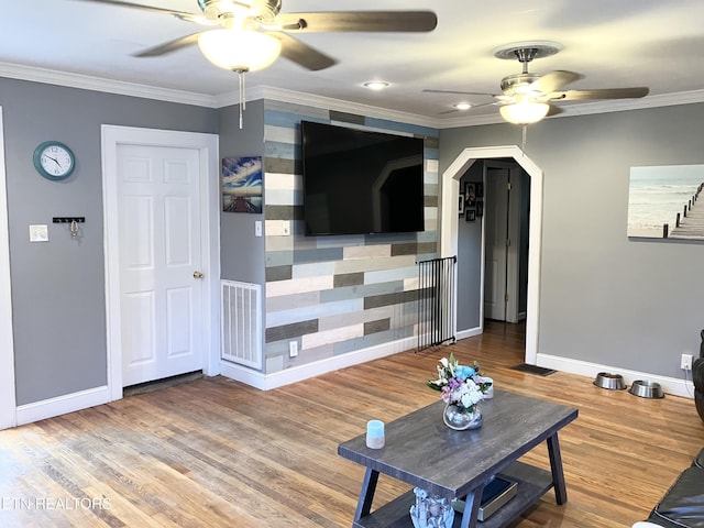 living room featuring ornamental molding, ceiling fan, and hardwood / wood-style flooring