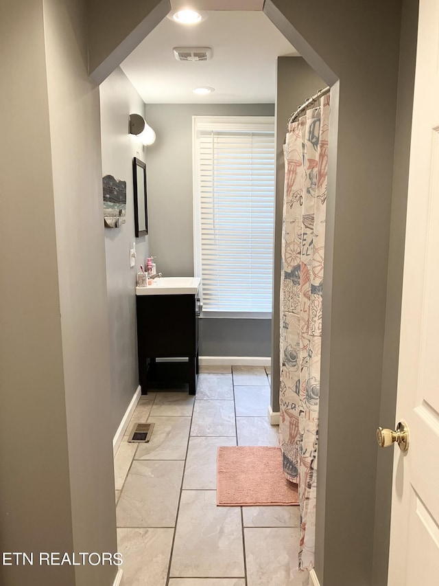 bathroom featuring tile patterned flooring and vanity