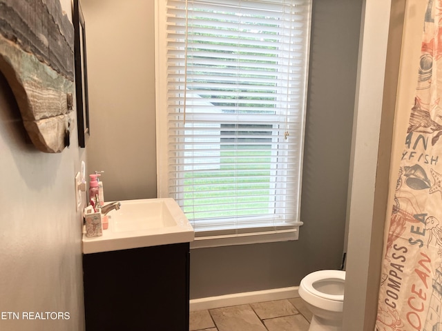 bathroom with tile patterned floors, vanity, and toilet