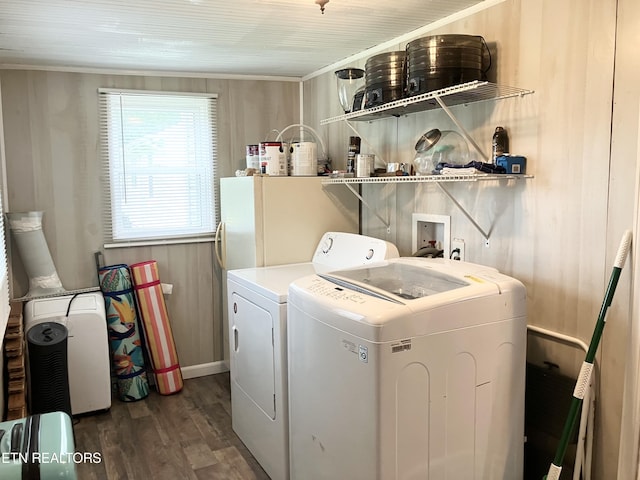 clothes washing area with wooden walls, dark hardwood / wood-style flooring, and independent washer and dryer