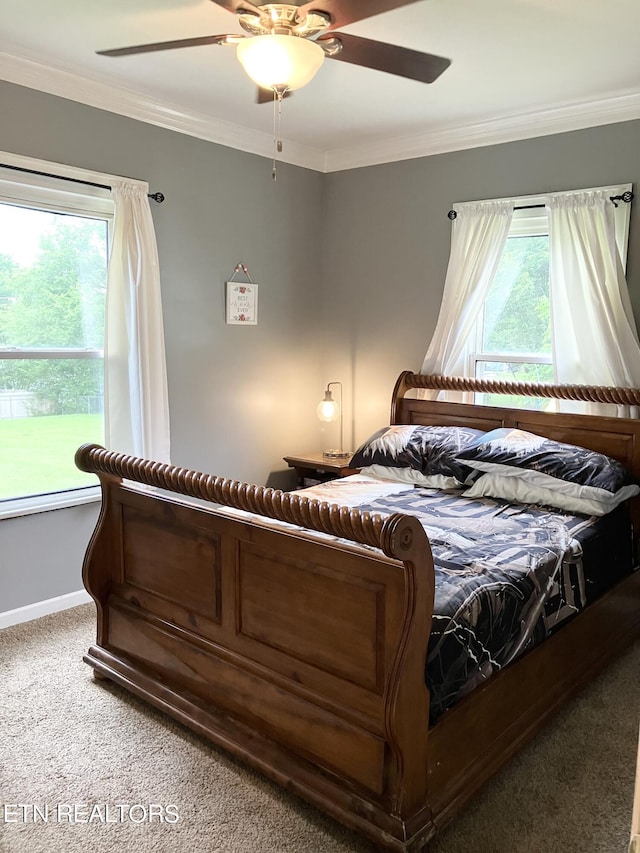 bedroom with ceiling fan, crown molding, and carpet flooring