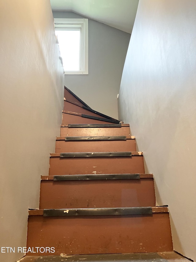 stairway featuring vaulted ceiling