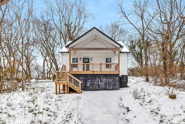 view of snow covered back of property