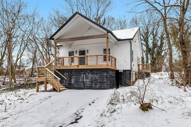 view of snow covered rear of property