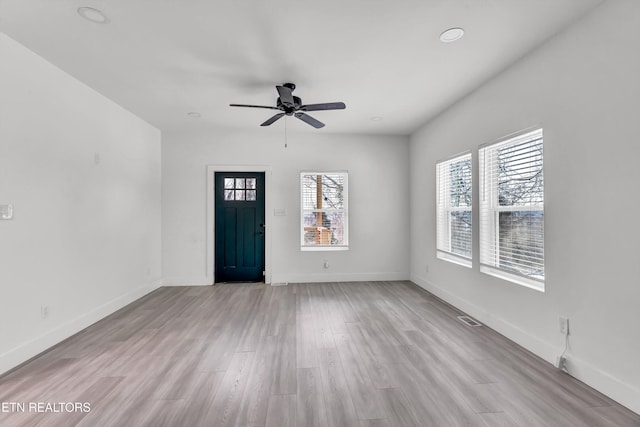 foyer featuring ceiling fan and light wood-type flooring