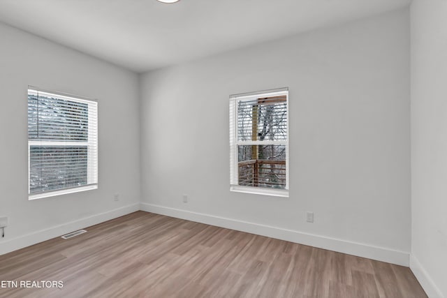 spare room with light hardwood / wood-style flooring