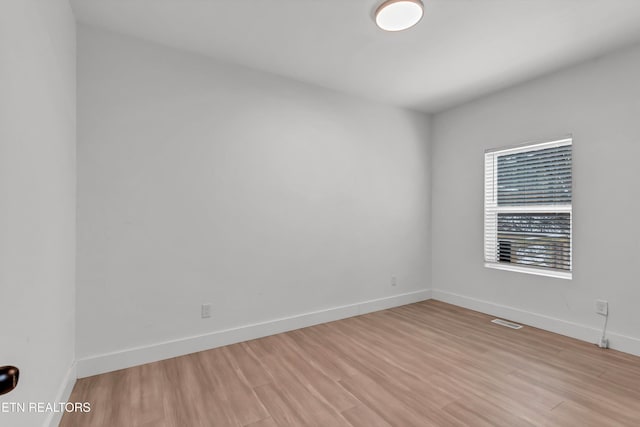 spare room featuring light hardwood / wood-style floors