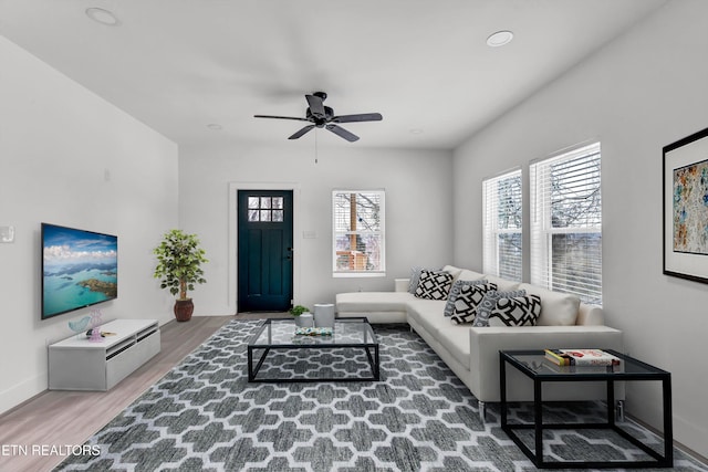 living room featuring hardwood / wood-style flooring and ceiling fan